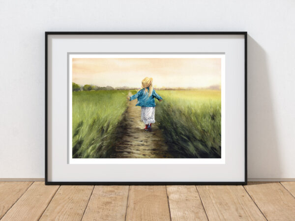 A girl walling through a field in red wellies, watercolour painting framed in black on a wooden floor